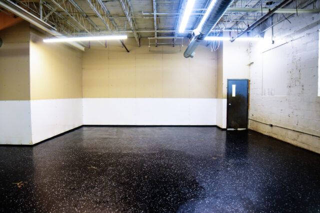 Empty industrial room with concrete walls and floor.